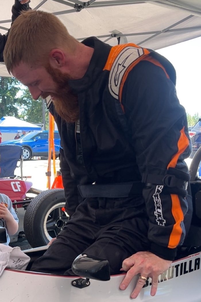 Bill laughing as he climbs into the car