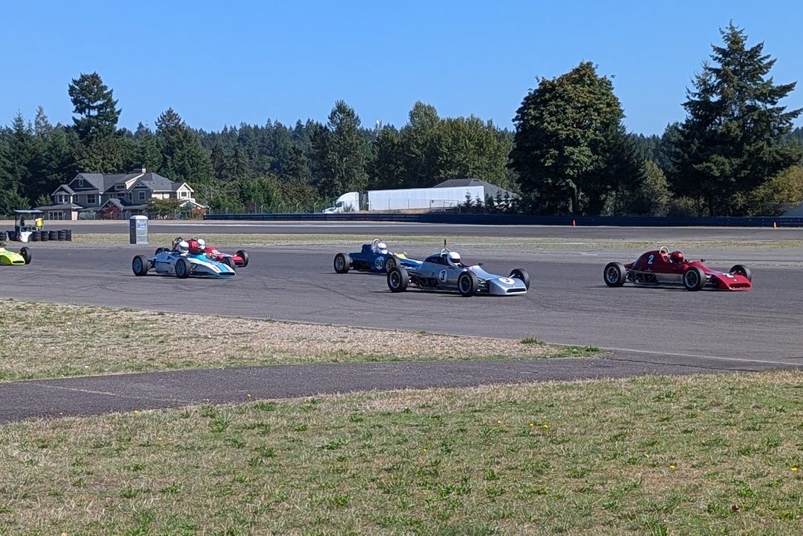 The number 3 Crosslé racing in a pack of vintage Formula Fords